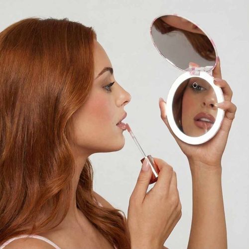 Taylor Lighted Compact open, lit up and being used to apply lip gloss