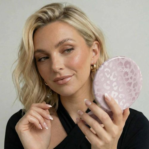 Model checking her look with Taylor Lighted Compact in Cosmic Cheetah