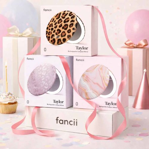 Taylor Lighted Compact show in boxes, stacked in Cheetah Chic, Cosmic Leopard, Marble Rose.