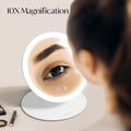 Abigail with Tara Travel Vanity Mirror by Fancii & Co. with 10x Magnifier showing precision details