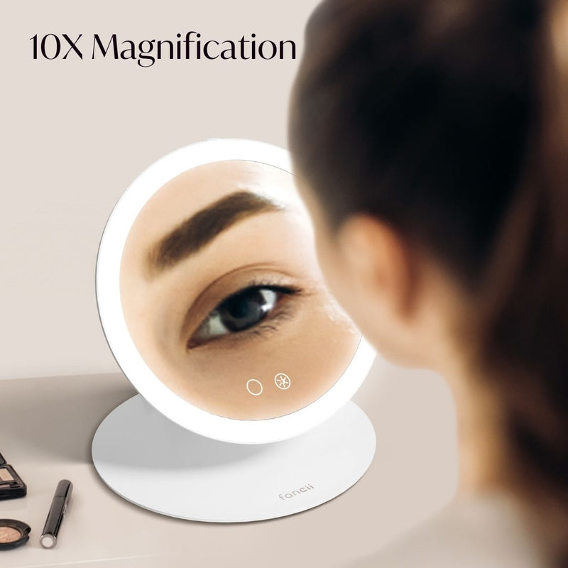Abigail with Tara Travel Vanity Mirror by Fancii & Co. with 10x Magnifier showing precision details