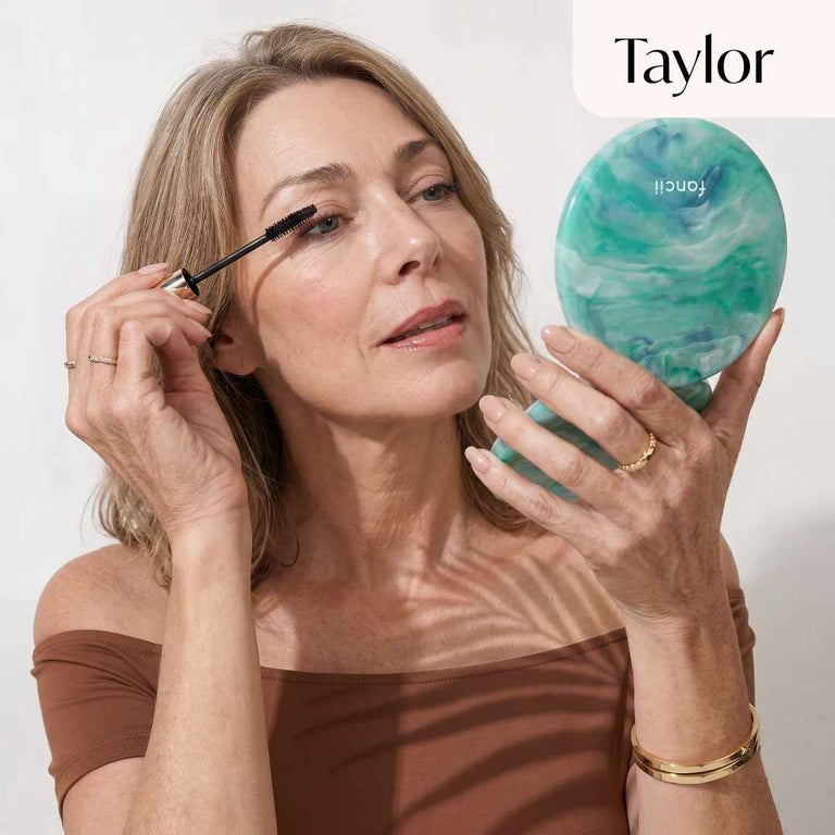 Model applies mascara using Taylor in Sea Serenity