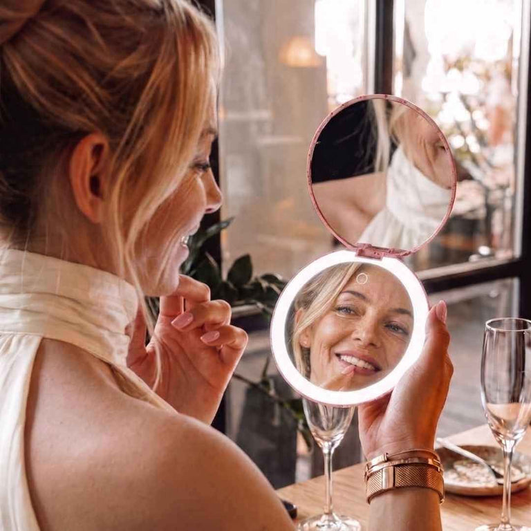 Taylor Lighted Compact by Fancii & Co. Open and being used to check teeth at resteraunt