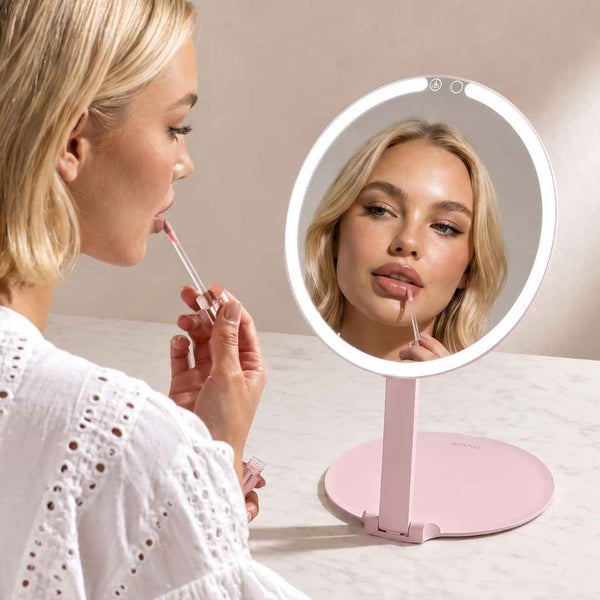 Fancii Abigail Travel Mirror with LED Lights Hero Extended Pink with Model applying lip gloss

Pink None
Pink 10x Magnifying Mirror 