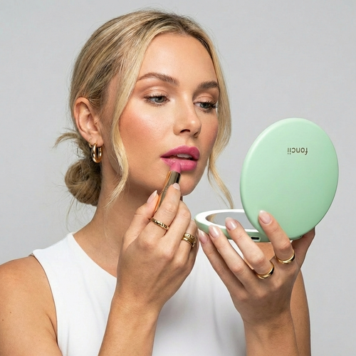 Taylor Lighted in Mint being used for a lip touchup